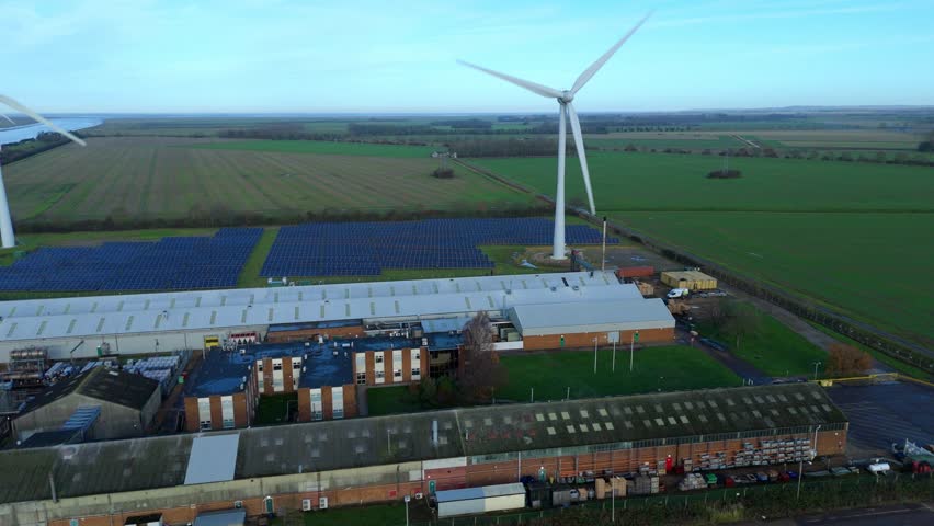 Wind turbines and solar panels in King's Lynn, United Kingdom, showcasing renewable energy efforts.