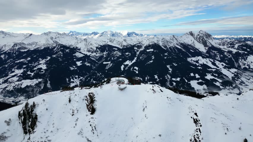 Aerial view of ski slopes at Dorfgastein ski resort in Gasteinertal valley, part of Ski Amade, showing snowy Alpine ridge and scenic winter panorama.
