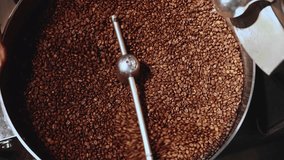 Freshly roasted brown coffee beans cooling and stirring process showcased in dynamic sequence. - Powered by Shutterstock - Get 15% off with code: PIKWIZARD15