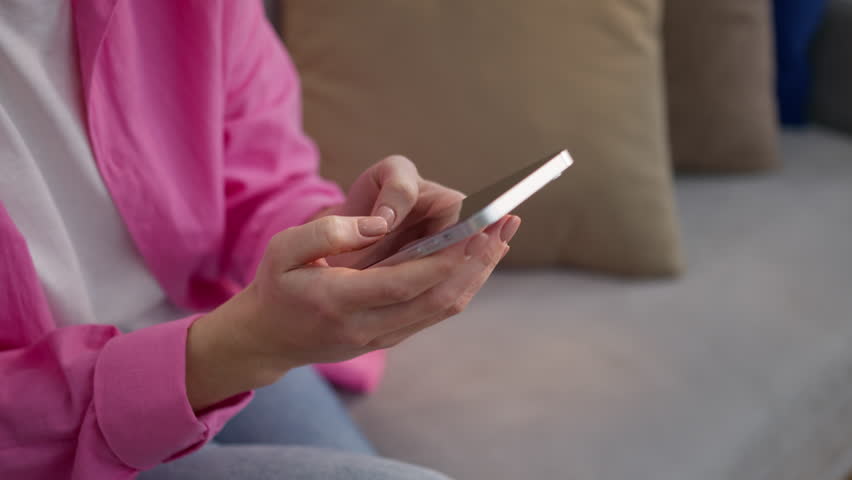Close up unknown Caucasian woman at home typing mobile phone texting female girl user chatting business customer using smartphone social media apps buy ordering goods online shopping indoors apartment