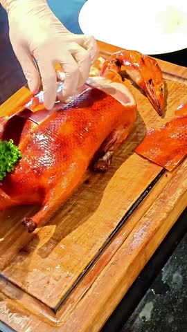 Chef carving up roast Peking duck, Chinese Restaurant Food, Lunar New Year, Crispy Hong Kong Roasted Meat, Luxury Dinner Lunch Service