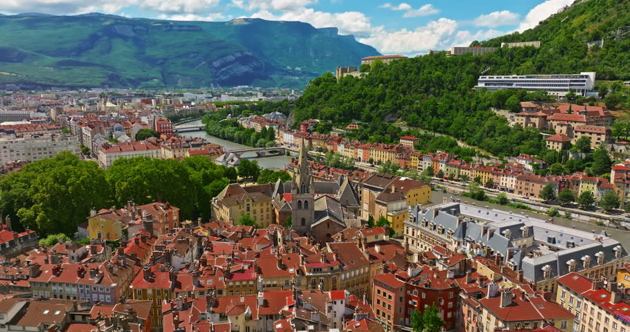 Aerial view of Grenoble. Panoramic view featuring the Isere river, urban landscape, mountains in the French Alps at summer