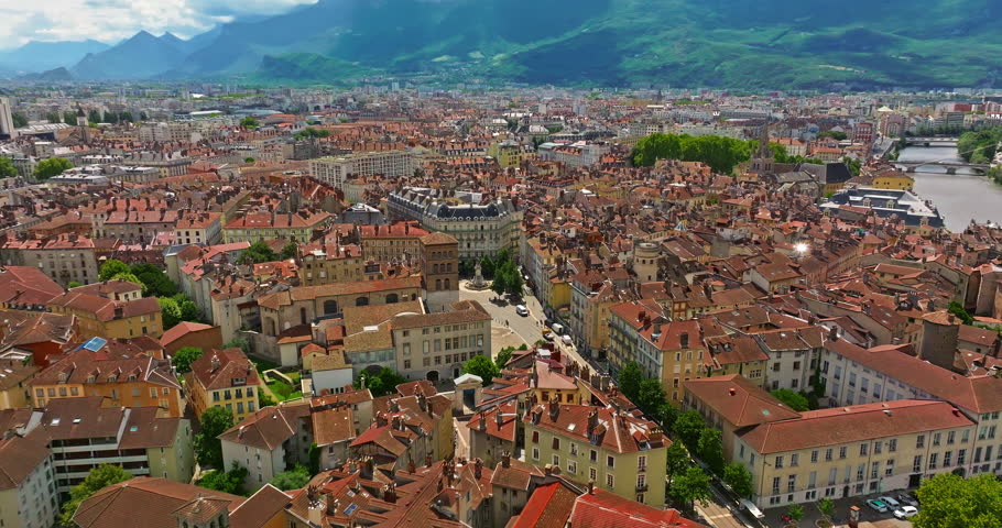 Aerial view of Grenoble. Panoramic view featuring the Isere river, urban landscape, mountains in the French Alps at summer