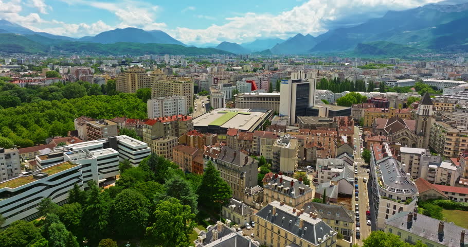 Aerial view of Grenoble. Panoramic view featuring the Isere river, urban landscape, mountains in the French Alps at summer