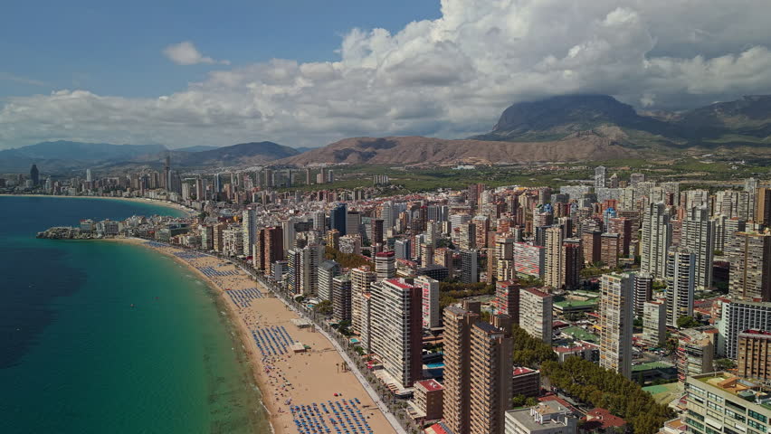 Aerial view of Benidorm coastline with skyscrapers, sandy beach and Mediterranean Sea Spain. High quality 4k footage