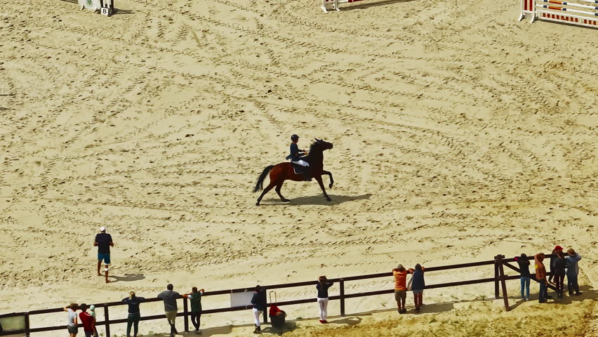Aerial view of equestrian competition outdoors jumping hurdle