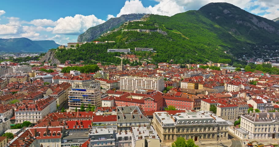 Aerial view of Grenoble. Panoramic view featuring the Isere river, urban landscape, mountains in the French Alps at summer