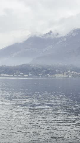 Untouched nature scene with clear lake, mountain peaks and expansive sky