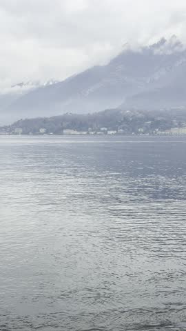Scenic mountain landscape with a calm body of water in the foreground. Majestic peaks reflected on the lake surface create a peaceful and natural atmosphere
