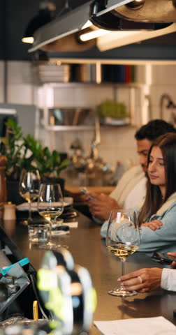Payment, phone and scan with person at bar for bartender service, digital transaction and mobile app. Pos machine, tap and online banking with people at restaurant pub for waiter and nfc purchase