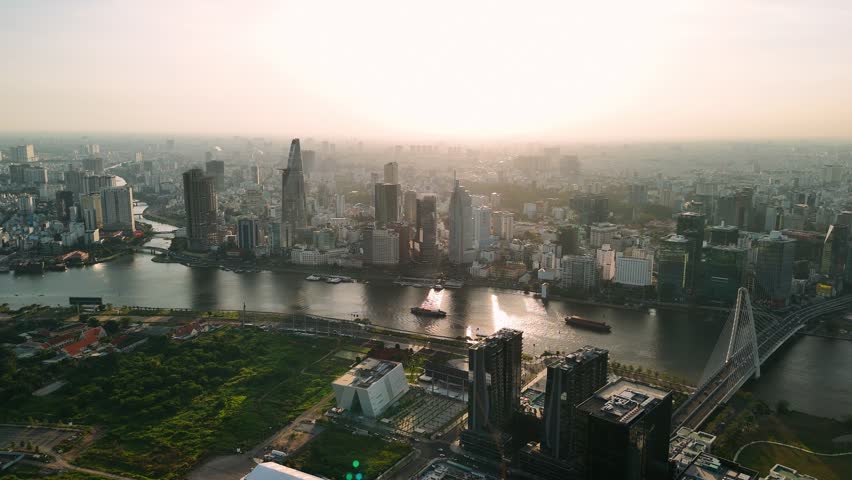Aerial view of ho chi minh city skyline with saigon river at sunset, vietnam.