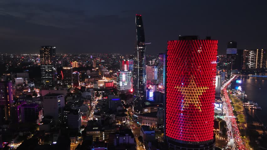 Skyscraper illuminating ho chi minh city skyline with vibrant lights at night.