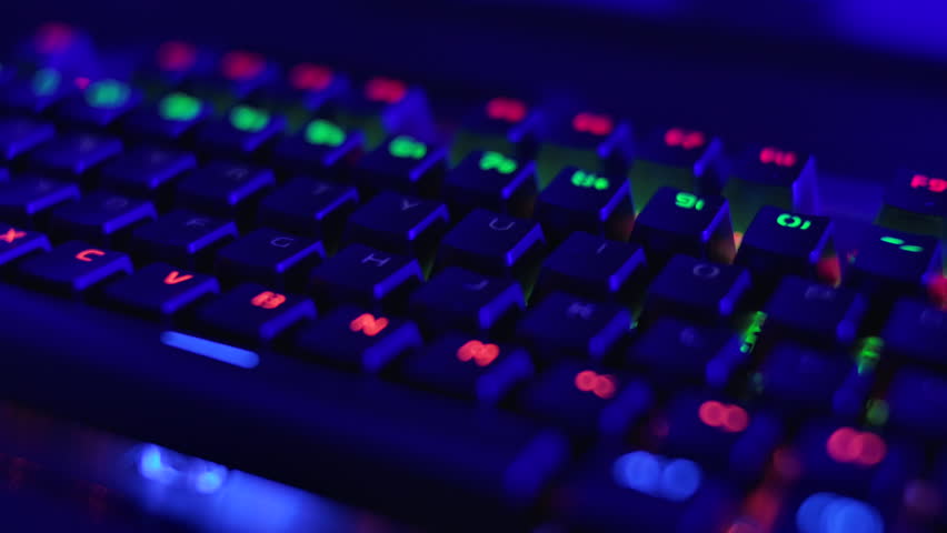 Gaming Keyboard With Rainbow of Colors Letters. PC RGB Keyboard is Glowing Neon Colors. Modern Backlit Keyboard With Pulsating RGB Colour Light. Cyber Sport Illuminated Mechanical Gaming Keyboard.