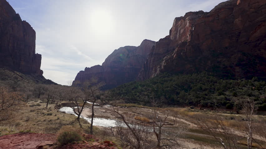 View looking down Zion Canyon from a vehicle driving down the road in the Utah desert.