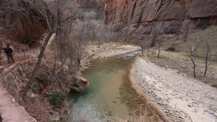 Tilt up looking down the Virgin River in Zion Canyon in the Utah desert.