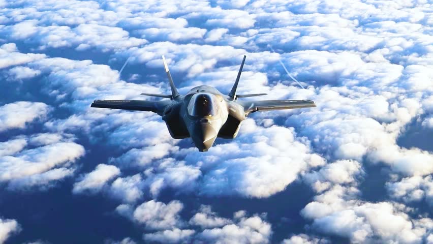 Stealth Fighter Jet F-35 Cruises Above Towering Clouds During High Altitude Strategic Patrol Mission.