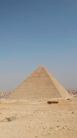Panning real-time footage of Giza pyramid complex and vast desert landscape of Giza plateau, Greater Cairo, Egypt. UNESCO World heritage site