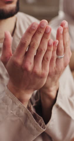 Muslim, man and hands in home with prayer, spiritual belief and worship Allah for Ramadan Kareem. Islamic person, religious and salah in apartment with peace, gratitude and dua for connection to God.