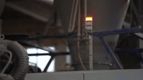 Industrial alert light shifts from red to clear, signaling a change in operational status within a manufacturing facility filled with machinery - Powered by Shutterstock - Get 15% off with code: PIKWIZARD15