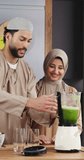 Muslim couple, blender and smoothie in kitchen for breakfast shake, digestion or health benefits. Islamic people, love and green beverage in home for nutrition, meal replacement and conversation - Powered by Shutterstock - Get 15% off with code: PIKWIZARD15