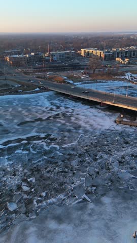 Aerial of Green Bay Wisconsin in Winter at Dusk.  Approaching drone shot of Leo Frigo bridge and local industries.