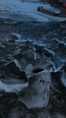 Aerial of the frozen Fox River and Green Bay Wisconsin at Dusk.  Right to left drone of ice.