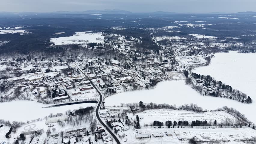 Aerial winter view of Granby city with snowy streets, church buildings and urban landscape, Quebec, Canada. g