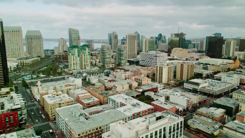 Aerial view of the San Diego skyline on a cloudy day, highlighting waterfront skyscrapers, harbor views, and coastal California cityscape.
