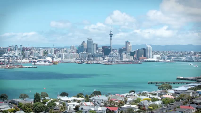 Auckland city skyline with the iconic Sky Tower on a bright sunny day, showcasing urban architecture, modern cityscape, and New Zealand landmarks.