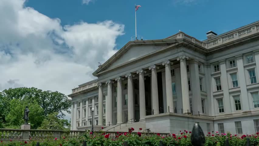 Timelapse of the US Treasury Building in Washington, D.C., with clouds passing overhead, highlighting iconic architecture.