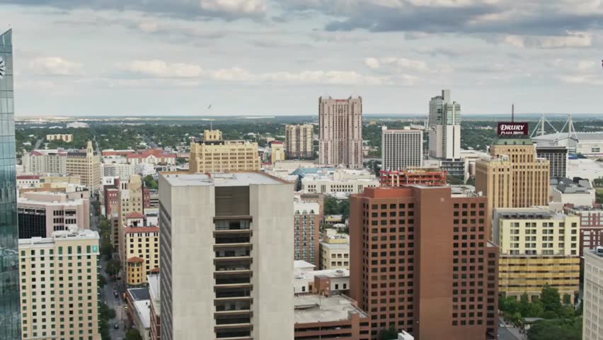 San Antonio cityscape featuring the Tower of the Americas on a cloudy day, highlighting urban skyline, iconic architecture, and Texas city views.