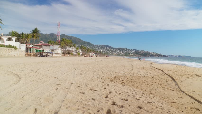Peaceful beach in Acapulco, Mexico with golden sand, palm trees and Pacific Ocean views. Tropical destination perfect for vacation, relaxation, summer escape and travel.