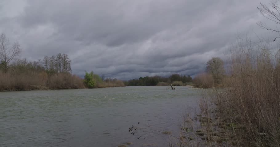 A fast paced timelapse shows the flowing American River in Sacramento