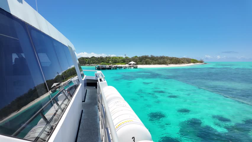 A tourist passenger ferry makes it way to Heron Island Resort located on the Southern Great Barrier Reef Queensland Australia
