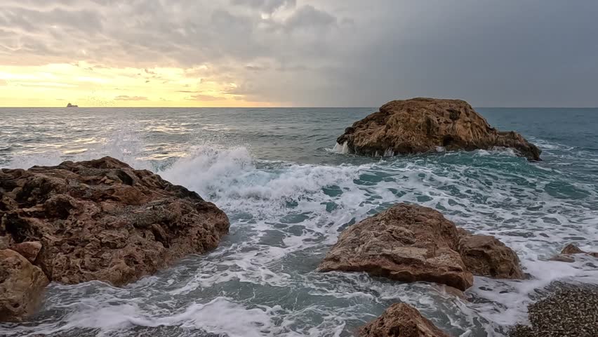 scenic coastal landscape with waves and stones