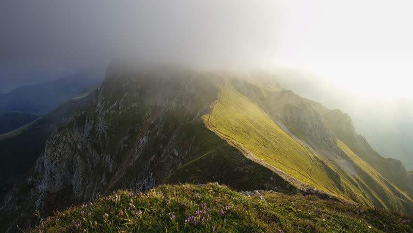 Time lapse of a mountain range, Ennstal Alps, Styria, Austria. Their peaks shrouded in mist. Rugged terrain in Austrian Alps. Wanderlust
