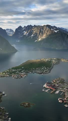Picturesque fishing village of Reine in Norway with mountains and fjords on a cloudy summer day