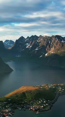 Stunning aerial footage flying over the famous fishing village of Reine in the Lofoten Islands, Norway