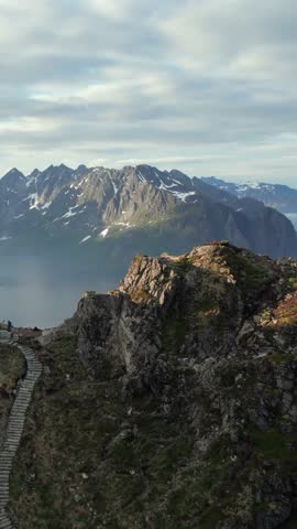Breathtaking aerial footage reveals the iconic Norwegian fishing village of Reine from a mountaintop