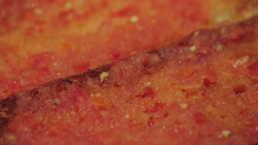 Pan con tomate a traditional dish of Catalan cuisine. Lightly toasted slice of white bread rubbed with garlic and tomato with the addition of olive oil and salt. High quality 4k footage