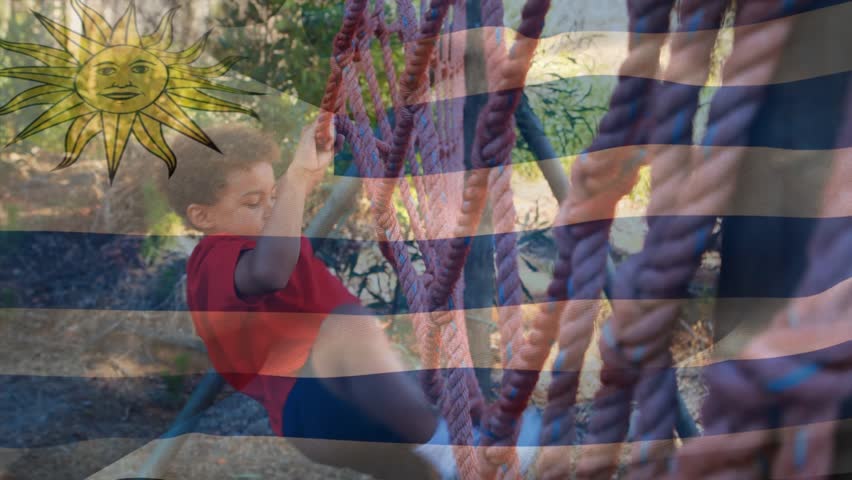 Animation of flag of argentina over caucasian boy during obstacle race training. national sports, activity and patriotism concept digitally generated video.