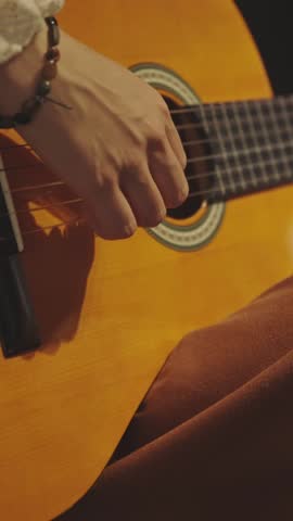 A woman in folk clothes playing guitar