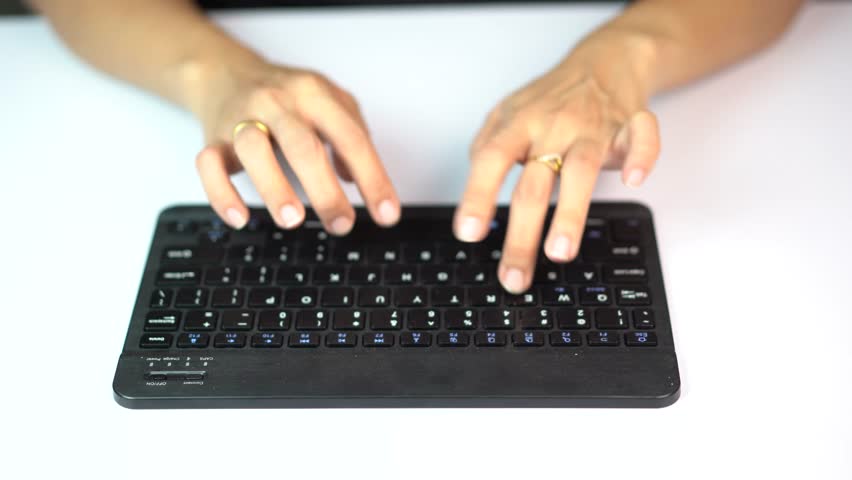 Top View of Female Hands Typing on Black Wireless Keyboard