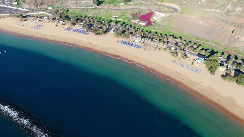 Aerial panorama of Playa de Las Teresitas golden sand beach and turquoise ocean gradients in Tenerife Canary Islands