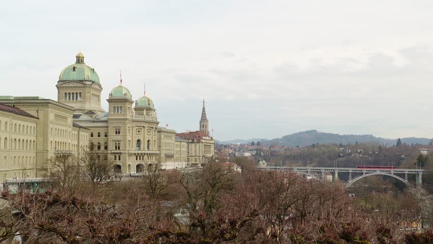 South Side of Federal Palace of Switzerland and Tram Going on Kirchenfeldbrucke Bridge. Bern, Switzerland. View from Kleine Schanze