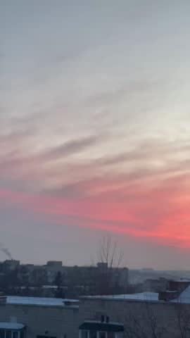 Beautiful orange sunset over the winter city skyline.