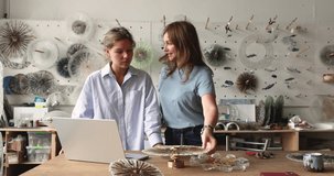 Two artisan women working on new art project, discussing, reviewing glasswork decor and using laptop in creative workshop studio. Teamwork, collaborative design workflow, small business, craftsmanship - Powered by Shutterstock - Get 15% off with code: PIKWIZARD15