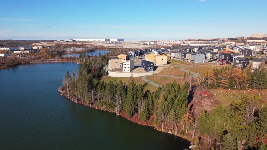 Drone aerial shot of wooden frame structures of modern expensive houses under construction in Beechville suburb of Halifax. Nova Scotia housing development boom, sunny winter day in Canada 4K.