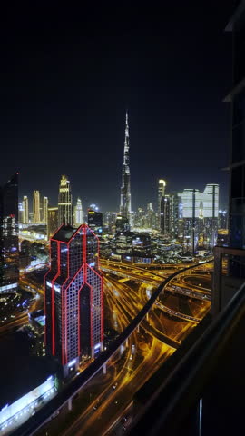 Dubai night skyline with Burj Khalifa and Maze tower, glowing highways and skyscrapers, fast urban life in a smart future city.