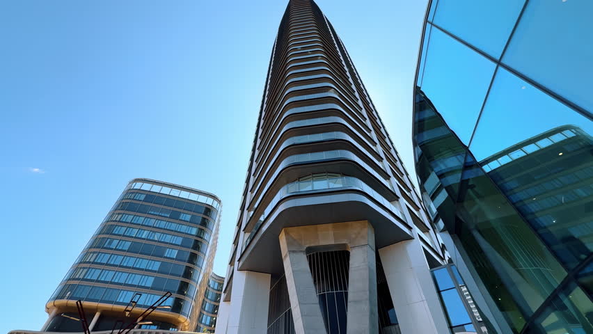 Modern design of the high-rise building in the scenery of the city. Low angle view at the tower in Bratislava, Slovakia.